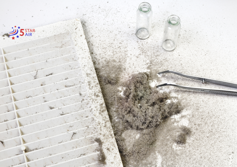 A 5 Star Air technician performing a lab-style analysis of thick grey dust, hair, and debris collected from a dirty white plastic HVAC return vent using tweezers and sample vials.